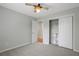 Bright bedroom featuring a fan, a closet with sliding doors, and neutral carpeting at 1074 Fieldstone Dr, Canton, GA 30114