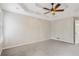 Large bedroom showcasing a tray ceiling, ceiling fan and plush carpeting at 1074 Fieldstone Dr, Canton, GA 30114