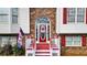 Close up of a bright red front door with decorative glass and sidelights at 1074 Fieldstone Dr, Canton, GA 30114