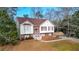 Charming home featuring a brick facade, red shutters, a bay window and a well-manicured lawn at 1074 Fieldstone Dr, Canton, GA 30114