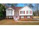 Charming two-story home with brick accents, a red front door, and a well-manicured lawn at 1074 Fieldstone Dr, Canton, GA 30114