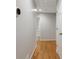 A hallway with hardwood floors, white walls, and doors leading to various rooms at 1074 Fieldstone Dr, Canton, GA 30114