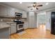 Well-lit kitchen features stainless steel appliances and wood flooring at 1074 Fieldstone Dr, Canton, GA 30114