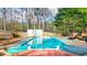 Inviting backyard pool with a colorful deck, surrounded by a wooden fence and mature trees at 1074 Fieldstone Dr, Canton, GA 30114