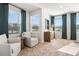 Bright sitting area features two chairs, wood side table, a dresser and a view of outside at 11561 Kimberly Way # 24, Hampton, GA 30228