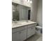 Modern bathroom with double sinks, quartz countertops, and a large mirror at 2108 Amaryllis Dr, Grayson, GA 30017