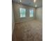 Bright bedroom featuring two windows and neutral colored carpet at 2108 Amaryllis Dr, Grayson, GA 30017