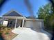 Charming one-story home featuring a two-car garage and a beautifully landscaped front yard on a sunny day at 2108 Amaryllis Dr, Grayson, GA 30017