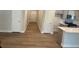 An open layout showcases a kitchen with an island, complemented by sleek hardwood floors and neutral wall colors at 2108 Amaryllis Dr, Grayson, GA 30017