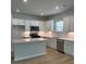 Modern kitchen with stainless appliances, custom white cabinets, and a center island at 2108 Amaryllis Dr, Grayson, GA 30017