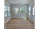 Inviting room featuring large windows, hardwood floors, and neutral paint at 2108 Amaryllis Dr, Grayson, GA 30017