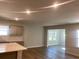 An open-concept living room showcases stylish wood flooring, recessed lighting, and expansive windows at 2108 Amaryllis Dr, Grayson, GA 30017