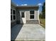 The home features a concrete patio complemented by stone accents and a door leading to the yard at 2108 Amaryllis Dr, Grayson, GA 30017