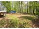 Expansive backyard featuring a storage shed, mature trees, and ample space for recreation and relaxation at 2724 Bomar Rd, Douglasville, GA 30135