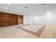 Unfinished basement with tile flooring, built in shelving and recessed lighting at 2724 Bomar Rd, Douglasville, GA 30135