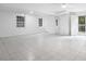 Spacious basement featuring tile flooring, a ceiling fan and a door leading outside at 2724 Bomar Rd, Douglasville, GA 30135