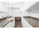 Bathroom featuring white cabinets, granite countertops, and brown tiled floors at 2724 Bomar Rd, Douglasville, GA 30135