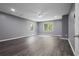Large bedroom with neutral walls, luxury vinyl floors, and bright, sunlit windows at 2724 Bomar Rd, Douglasville, GA 30135
