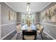 Elegant dining room with modern lighting, a stylish table setting, neutral paint, and a large window bay at 2724 Bomar Rd, Douglasville, GA 30135