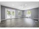 Bright living room featuring gray walls, wood-look flooring, and French doors to a deck at 2724 Bomar Rd, Douglasville, GA 30135