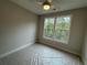 Bedroom with a ceiling fan, carpet, and two large windows offering serene views at 455 Firefly Cir # 39, Alpharetta, GA 30009