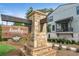 Firefly community entrance sign featuring stone and wood accents, adjacent to modern homes at 455 Firefly Cir # 39, Alpharetta, GA 30009