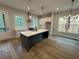 Contemporary kitchen with a large island, stainless steel appliances, and hardwood floors at 455 Firefly Cir # 39, Alpharetta, GA 30009