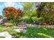 Landscaped backyard featuring stone steps and lush greenery, creating a serene outdoor space at 207 Cole Ct, Canton, GA 30114