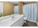 Bathroom with a white vanity and sink, toilet, and shower with blue curtain at 207 Cole Ct, Canton, GA 30114