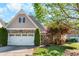 Charming home featuring a stone facade, two-car garage, and well-manicured lawn at 207 Cole Ct, Canton, GA 30114