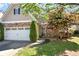 Charming home featuring a stone facade, two-car garage, and well-manicured lawn at 207 Cole Ct, Canton, GA 30114