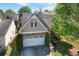 Inviting front exterior with a two car garage and manicured landscaping enhances curb appeal at 207 Cole Ct, Canton, GA 30114