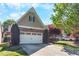 Charming home featuring a stone facade, two-car garage, and well-manicured lawn at 207 Cole Ct, Canton, GA 30114