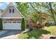 Charming home featuring a stone facade, two-car garage, and well-manicured lawn at 207 Cole Ct, Canton, GA 30114