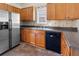 Well-lit kitchen with stainless steel refrigerator and black dishwasher, providing ample counter space at 207 Cole Ct, Canton, GA 30114