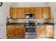 Traditional kitchen features stainless steel appliances, wood cabinets, and solid surface countertops at 207 Cole Ct, Canton, GA 30114