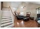 Inviting living room features vaulted ceilings, hardwood floors, and staircase at 207 Cole Ct, Canton, GA 30114