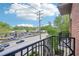 Balcony view of shopping center, street with traffic, and powerlines on a partly cloudy day at 2277 Peachtree Ne Rd # 310, Atlanta, GA 30309