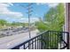 View from the balcony overlooking a bustling street with shops and greenery in the distance at 2277 Peachtree Ne Rd # 310, Atlanta, GA 30309