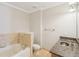 Bathroom featuring a bathtub with stone accents, granite countertops, and tile flooring at 2277 Peachtree Ne Rd # 310, Atlanta, GA 30309