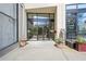 Building entrance with modern glass doors, planters, and clear signage at 2277 Peachtree Ne Rd # 310, Atlanta, GA 30309