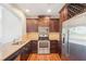 Well-equipped kitchen featuring granite countertops, stainless steel appliances, and dark wood cabinetry at 2277 Peachtree Ne Rd # 310, Atlanta, GA 30309