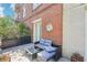 Cozy patio with brick wall, comfortable seating, and potted plants provides an inviting outdoor space at 2277 Peachtree Ne Rd # 310, Atlanta, GA 30309