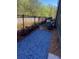 Cozy backyard with a black metal fence, landscaping, and gravel at 445 Firefly Cir # 40, Alpharetta, GA 30009