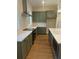 Well-equipped kitchen boasting stainless steel appliances and modern green cabinetry at 445 Firefly Cir # 40, Alpharetta, GA 30009
