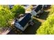 Aerial view of the home showcasing the roof, yard, and surrounding trees at 5789 Star Flower Dr, Ellenwood, GA 30294