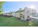 Backyard featuring green lawn and patio with a view of neighboring homes at 5789 Star Flower Dr, Ellenwood, GA 30294