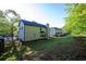 Wide shot of a well-maintained backyard with green lawn and mature trees at 5789 Star Flower Dr, Ellenwood, GA 30294