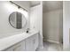 Bright bathroom with long vanity and black faucet plus a walk-in shower at 5789 Star Flower Dr, Ellenwood, GA 30294