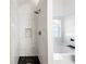 Sleek bathroom boasts tiled shower with niche and soaking tub at 5789 Star Flower Dr, Ellenwood, GA 30294